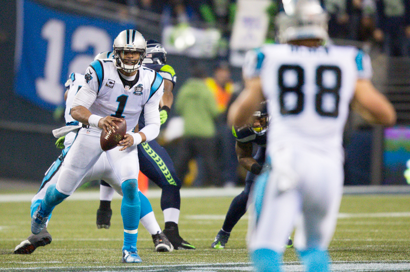 Panthers' quarterback Cam Newton eyes a reciever while under pressure. Newton overthrew for an incomplete.