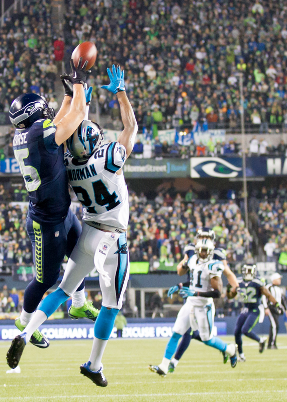 A Panther defender keeps Hawks receiver Jermaine Kearse from taking home a deep pass in the third quarter.