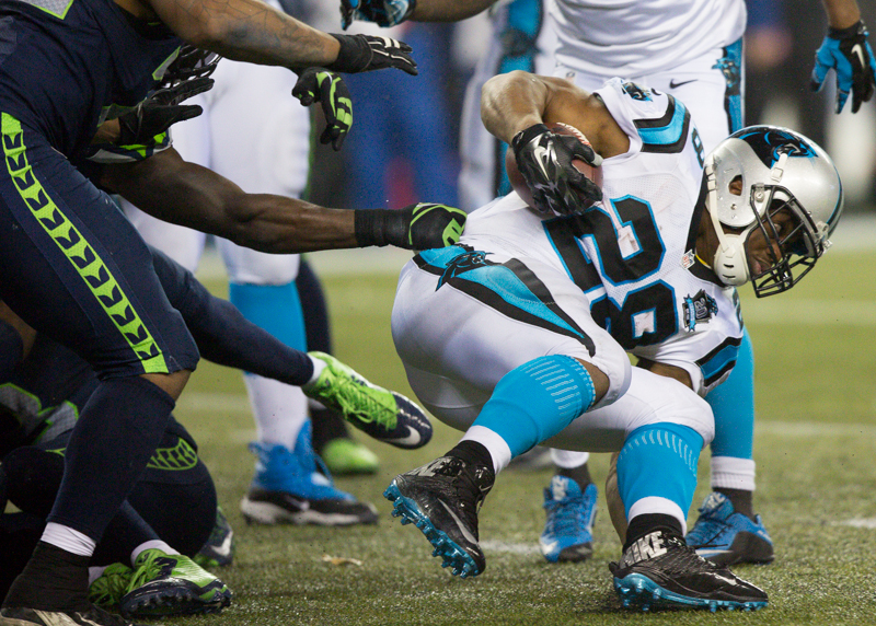 Determined to stay in play, a Panthers running back tries some fancy-footwork  for an 8-yard gain in the fourth quarter.