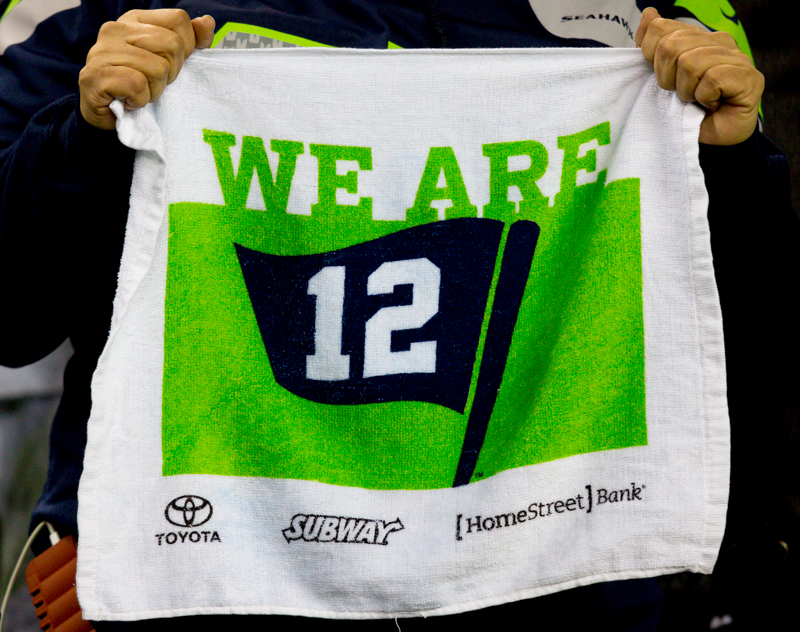 A fan holds up a "we are 12" towl in the fourth quarter.