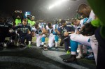 Players from both teams participate in the post-game prayer circle on the field after the game.