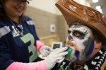 A fan has his face painted before the game.