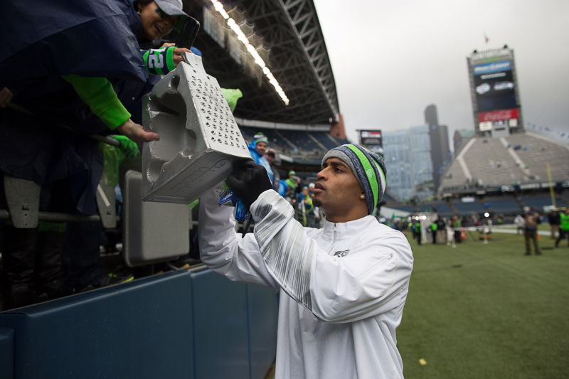Seahawks' receiver Doug Baldwin signs a cheese grater before the game.