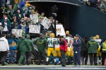 Packers players navigate their way through a sea of hostile Seahawks fans as they head back to the locker room before the game.