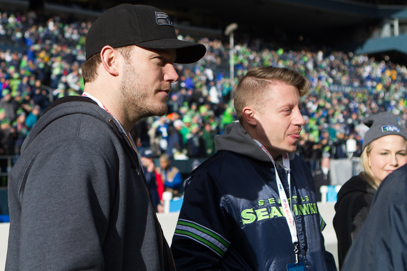 Actor Chris Pratt, left, hangs with Seattle MC Macklemore on the Seahawks' sideline during warm-ups.
