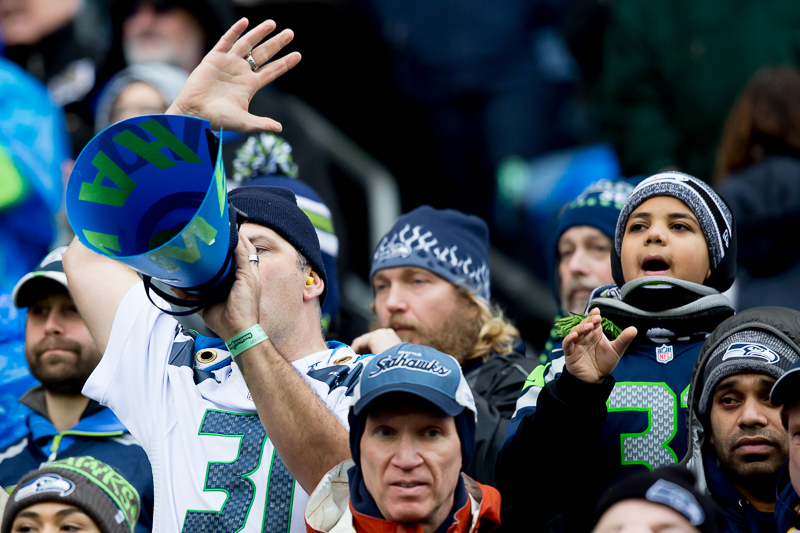  Russell Wilson holds up the NFC Championship trophy for all the 12s