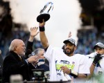  Russell Wilson holds up the NFC Championship trophy for all the 12s