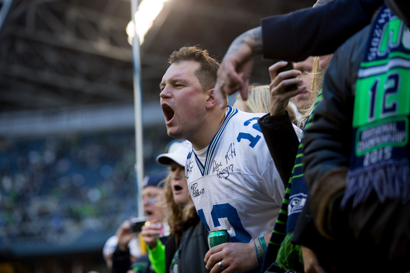 A fan cheers after the team wins the game, advancing to the Super Bowl.