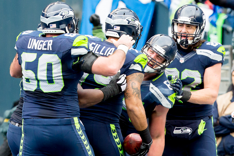 Teammates congratulate Seattle tackle Garry Gilliam after his unusual touchdown following an incredible trick play on a fourth down in the third quarter.