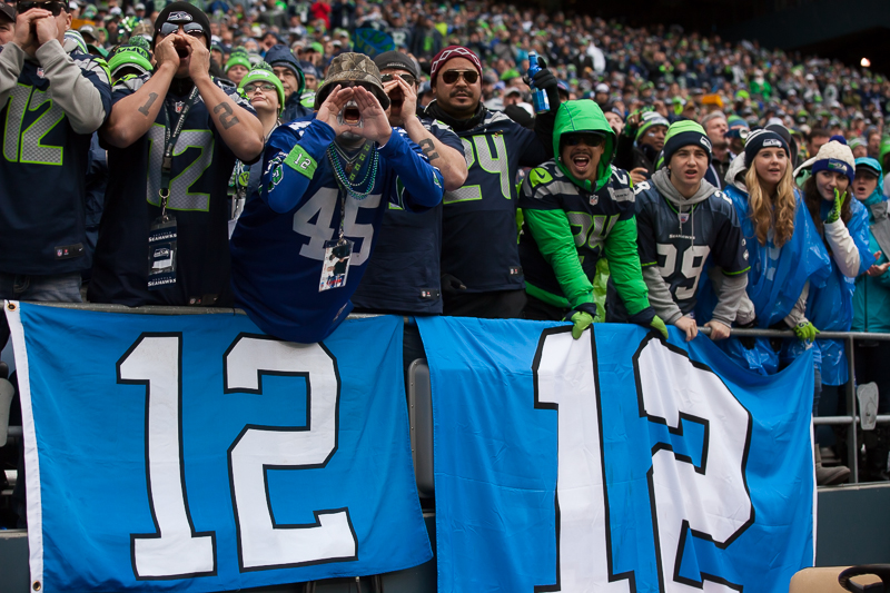  Russell Wilson holds up the NFC Championship trophy for all the 12s