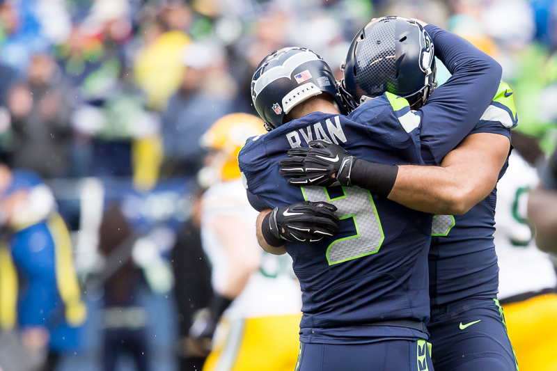 Place holder Jon Ryan gets a hug from Garry Gilliam after throwing the 19-yard touchdown pass on the faked field goal.