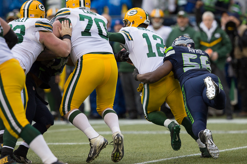 Seattle defensive end Cliff Avril sacks Aaron Rodgers for a loss.