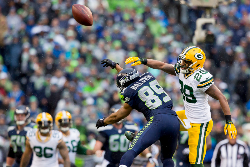 Seattle's Doug Baldwin is denied a pass by a Green Bay defender.