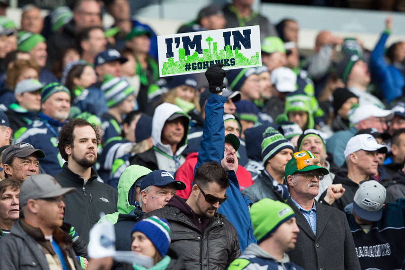  Russell Wilson holds up the NFC Championship trophy for all the 12s