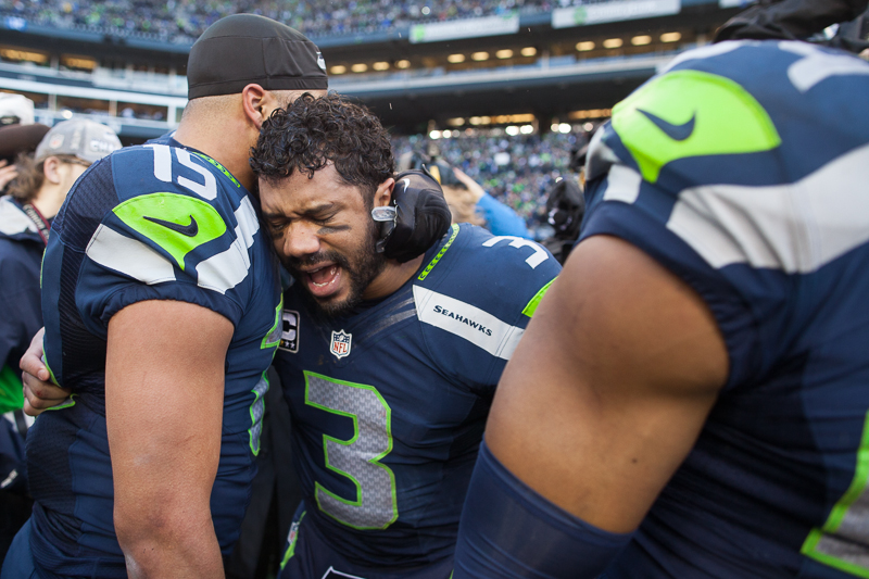 Overwhelmed with emotion, Seahawks quarterback Russell Wilson cries in the arms of his teammate Jermaine Kearse after clinching his second Super Bowl berth.