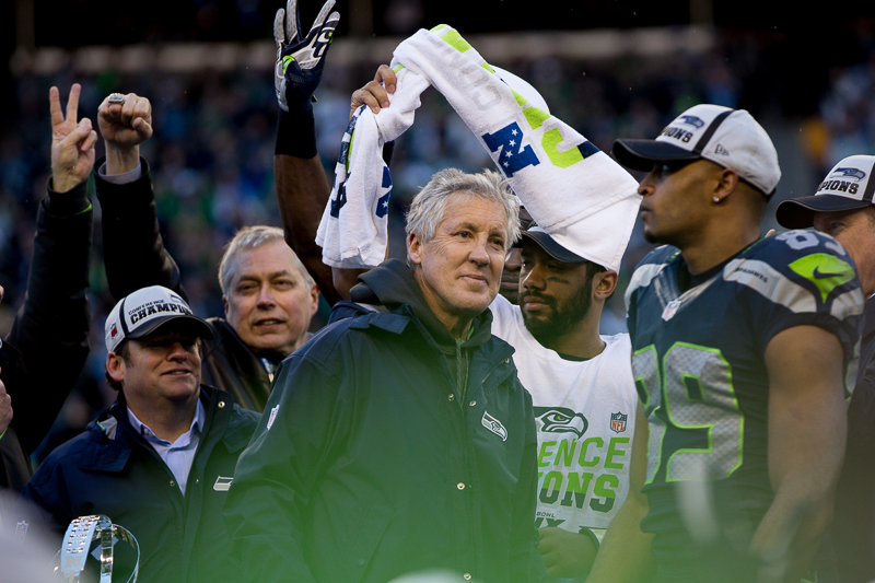  Russell Wilson holds up the NFC Championship trophy for all the 12s