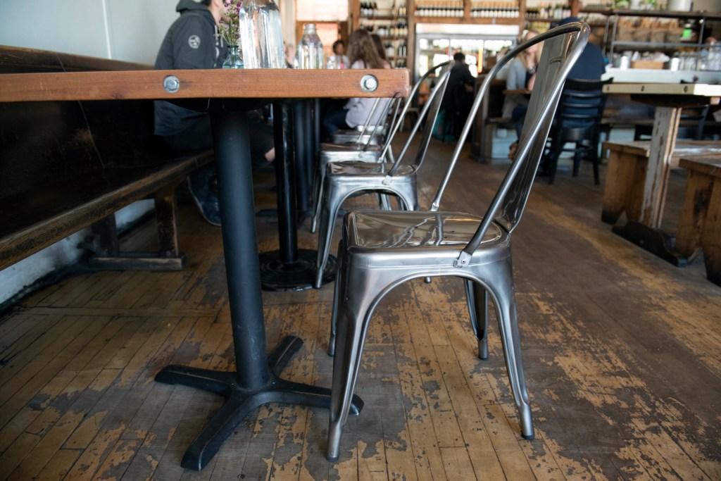 Top: an original Tolix Marais stool at Cicchetti. Bottom left: Oddfellows’ authentic Tolix Marais “A” chairs. Bottom right: Pizzeria Gabbiano’s knock-offs in red.