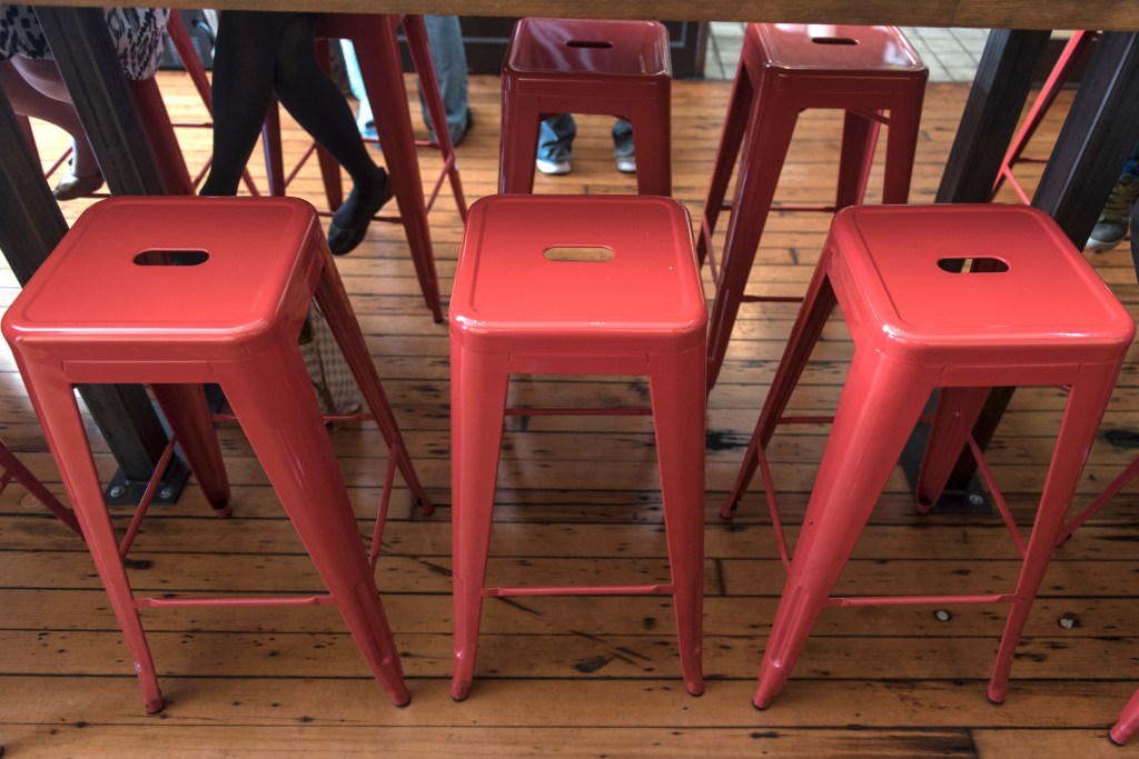 Top: an original Tolix Marais stool at Cicchetti. Bottom left: Oddfellows’ authentic Tolix Marais “A” chairs. Bottom right: Pizzeria Gabbiano’s knock-offs in red.