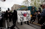 Anti-capitalist protesters march down Broadway in Capitol Hill.