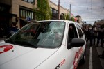 A KIRO radio vehicle sustains damage from protesters, who would go on to smash most of the windows.