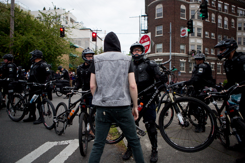 Police force protesters back with their bikes.