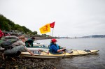 A kayaktivist gets a push as she heads out into the water.