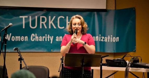 Tulin Yildiz speaks on the origin and significance of ashure in Turkish culture 
at Turkchas event at the Peter Kirk Community Center in Kirkland.                                 Photo courtesy of Dilek Anderson