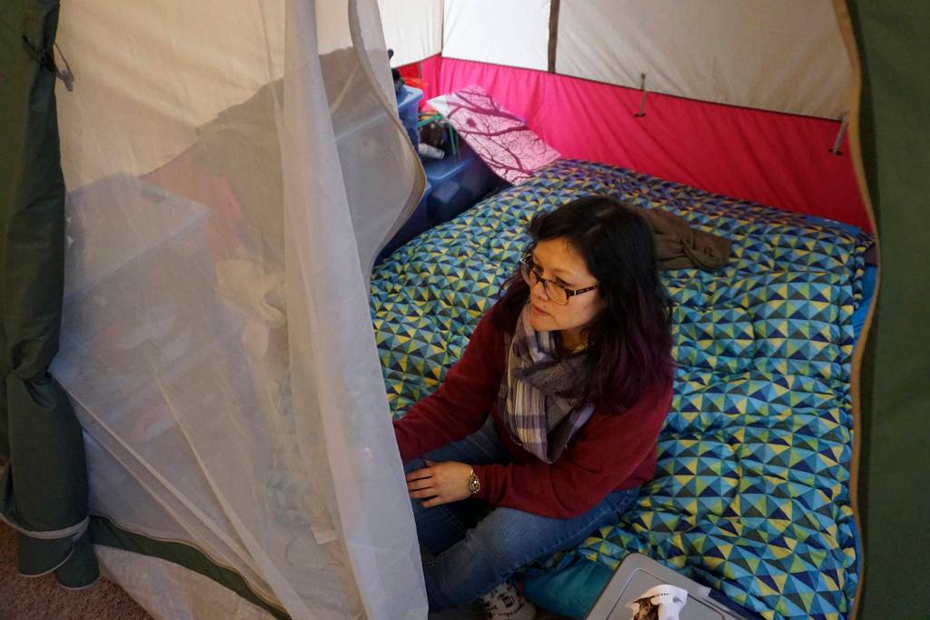 Christy X lives in a tent inside of her apartment because she says that pests make the unit uninhabitable. Photo by Melissa Hellmann
