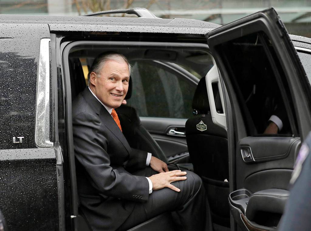 Washington Gov. Jay Inslee gets into an SUV after speaking March 6 on a nonpartisan panel discussion titled Foreign Affairs and National Security in the Age of Climate Change hosted by the University of Washington Jackson School and the American Security Project on the UW campus in Seattle. (AP Photo/Ted S. Warren, file)