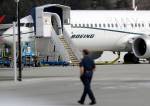 Ted S. Warren / associated press                                A worker walks next to a Boeing 737 MAX 8 airplane parked at Boeing Field in Seattle on Thursday.