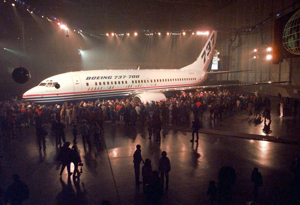 Boeing Co. employees view the first of three new Boeing 737-700 during rollout ceremonies on Dec. 8, 1996, at the Renton plant. This version, which included a 737-600 and 800 series, was longer and had better fuel efficency, speed and range. (AP Photo/Robert Sorbo, file)