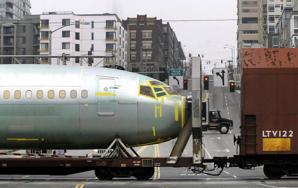 A Boeing 737 fuselage passes through Seattle on a railcar bound for a Boeing assembly plant in Renton onFeb. 9, 2004. (AP Photo/Ted S. Warren, file)