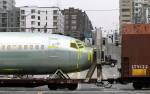 A Boeing 737 fuselage passes through Seattle on a railcar bound for a Boeing assembly plant in Renton onFeb. 9, 2004. (AP Photo/Ted S. Warren, file)