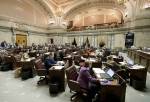 In this March 12 photo, Washington state Senators work on the Senate floor at the Capitol in Olympia. (AP Photo/Ted S. Warren)