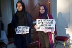 Ranya Ibrahim and Gowiria Yousif hand out signs outside the Muslim Association of Puget Sound mosque in Redmond. Ashley Hiruko/staff photo