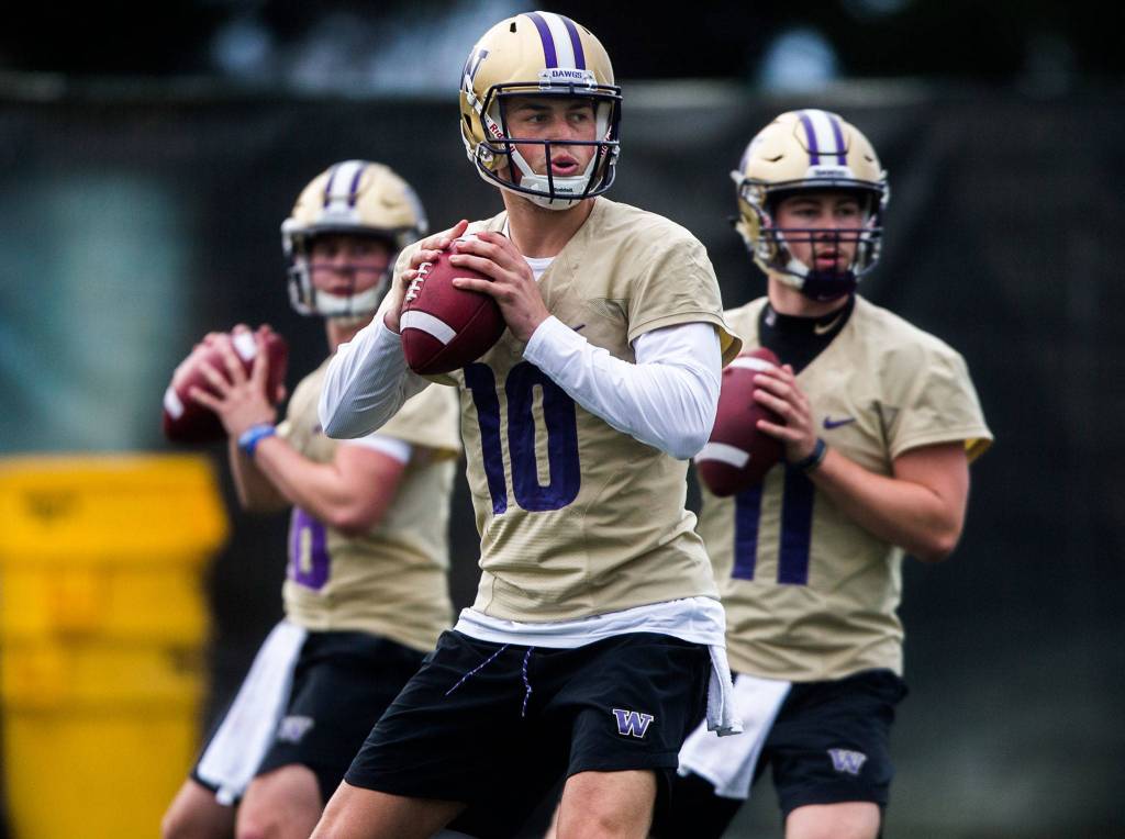Washington quarterback Jacob Eason (10), a Lake Stevens alum, runs through position drills during spring practice on April 3, 2019, in Seattle. (Olivia Vanni / The Herald)