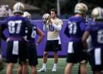 Washington quarterback Jacob Eason (10), a Lake Stevens alum, takes his helmet off between drills during spring practice on April 3, 2019, in Seattle. (Olivia Vanni / The Herald)