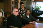 Father Steve Woodland, the Barcos priest at St. Philomena Church, pictured with Rocio and Bernardo in their Des Moines home. Haley Donwerth/staff photo