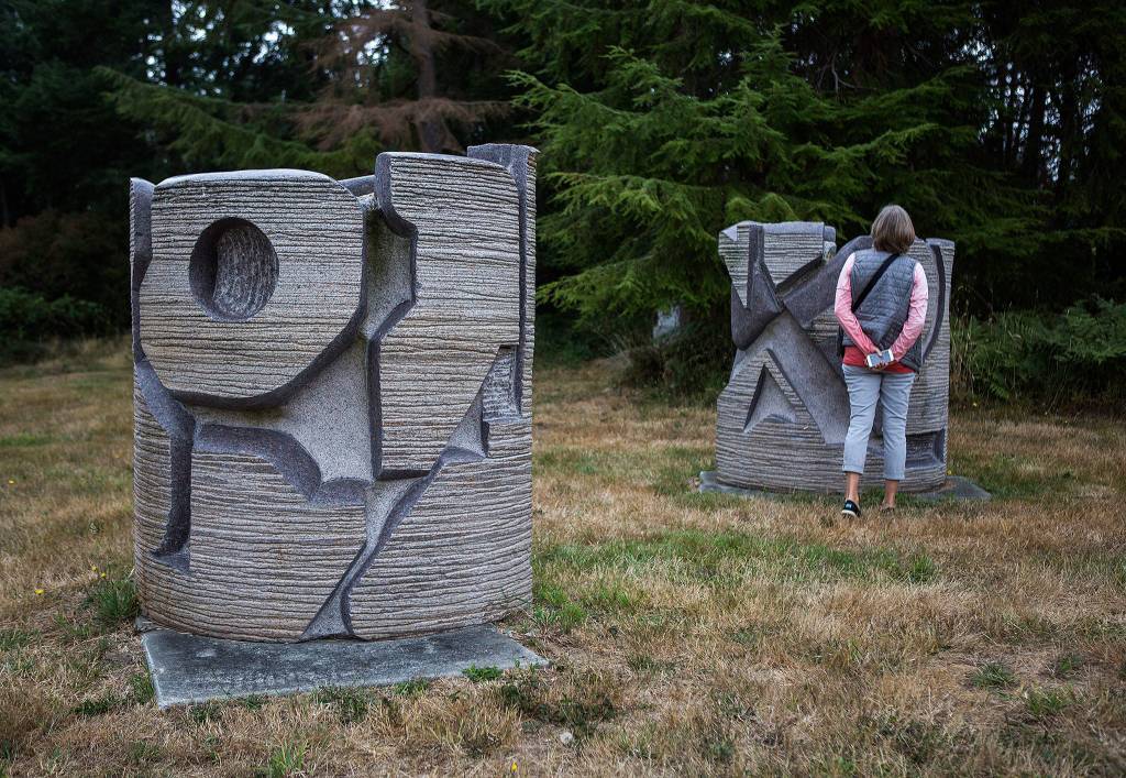 A visitor looks at a sculpture on the Cloudstone outdoor gallery in Freeland. (Olivia Vanni / The Herald)