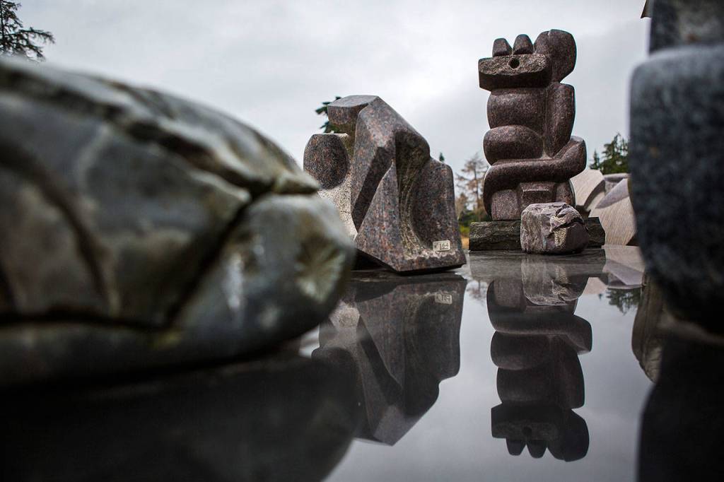 A sculpture is reflected off of a smooth surface at the Cloudstone outdoor gallery in Freeland. (Olivia Vanni / The Herald)