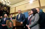 Gov. Jay Inslee, surrounded by Democratic lawmakers from the Senate and House, talks to the media following the Washington Legislature adjourning its 105-day legislative session Monday in Olympia. (AP Photo/Rachel La Corte)