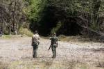 Washington State Fish & Wildlife officers Nicholas Jorg and Jesse Ward wait for dogs to return from chasing Black Pearl into the woods in the Cascade Mountains on Tuesday. (Andy Bronson / The Herald)