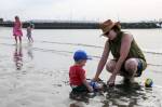 Barb Parnell (right) plays with Gage Tinker on Sunday afternoon at Olympic Beach in Edmonds. (Kevin Clark / The Herald)