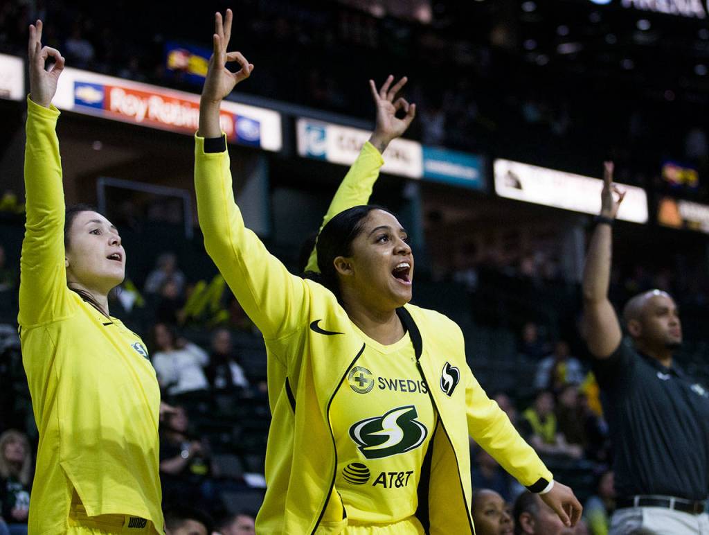 Seattles Recee Caldwell celebrates on the bench after a Storm teammate made a 3-pointer during a preseason game against Phoenix on Wednesday at Angel of the Winds Arena in Everett. (Olivia Vanni / The Herald)