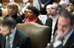 Washington state presidential electors Esther John (center) and Bret Chiafalo (right) sit behind their attorneys during a Jan. 22 Washington Supreme Court hearing in Olympia on a lawsuit addressing the constitutional freedom of electors to vote for any candidate for president, not just the nominee of their party. (Ted S. Warren / Associated Press, file)