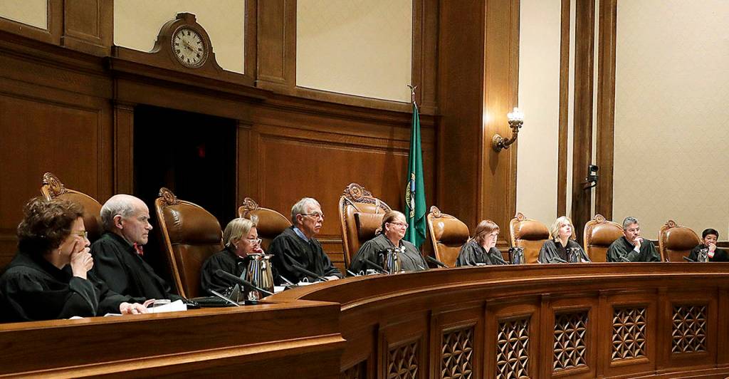 Justices on the Washington Supreme Court listen to testimony during a Jan. 22 hearing in Olympia, on a lawsuit addressing the constitutional freedom of state presidential electors to vote for any candidate for president, not just the nominee of their party. (AP Photo/Ted S. Warren, file)
