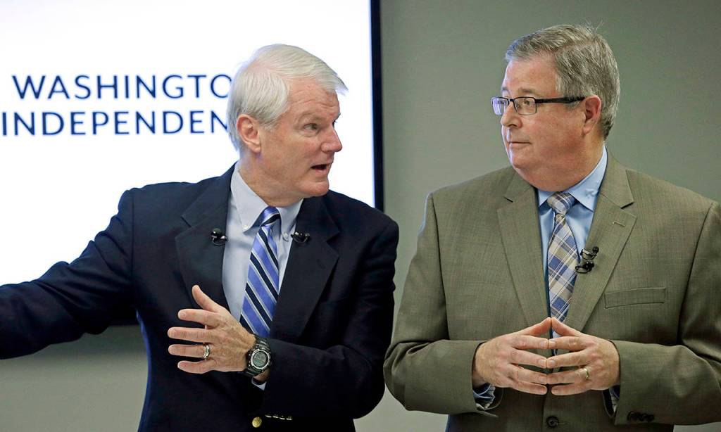 Former Democratic U.S. Rep. Brian Baird (left) and former Republican state Rep. Chris Vance speak at a news conference in 2017 to announce plans to promote centrist-minded politicians in Washington. (AP Photo/Elaine Thompson)