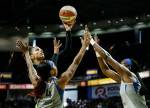 The Storms Alysha Clark shoots over two Lynx defenders during a game on June 4 at the Angel of the Winds Arena in Everett. (Andy Bronson / The Herald)