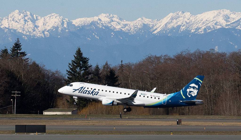With the Olympic mountains in the background, the first Paine Field passenger flight by Alaska Airlines departs for Portland on March 4. Alaska has announced a ninth destination  Palm Springs, California. (Andy Bronson / The Herald)