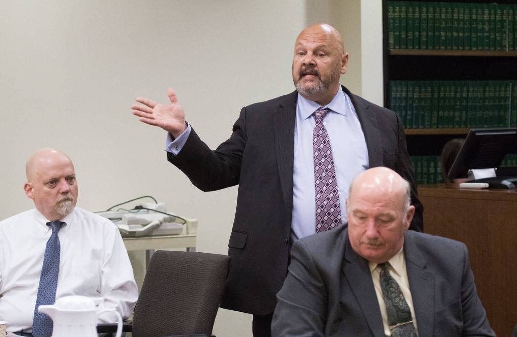 William Talbott II (left) listens as his public defender Jon Scott questions potential jurors at the Snohomish County Courthouse on Thursday in Everett. Snohomish County sheriffs detective Jim Scharf (right) listens from the prosecutors table. (Andy Bronson / The Herald)